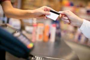 Close up of female hand paying with credit card in store